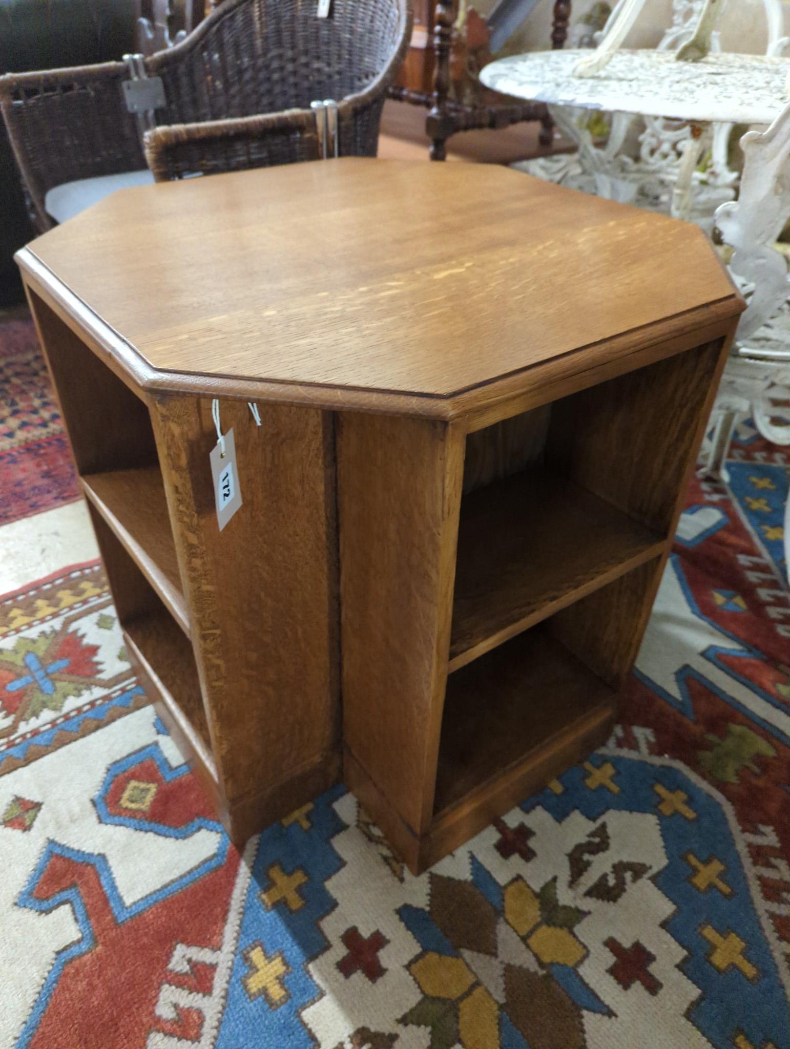 A 1930's Heals style octagonal golden oak book table, width 60cm, height 58cm